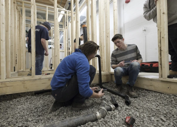 Two Men are Fixing Pipe