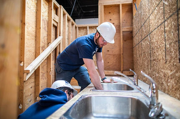 man is Fixing Kitchen Sink