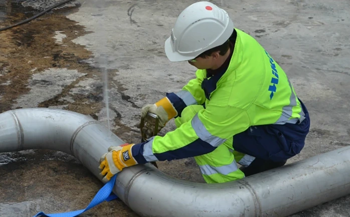 Plumbing technician repairing new metal piping during repiping project in Santa Barbara, CA.