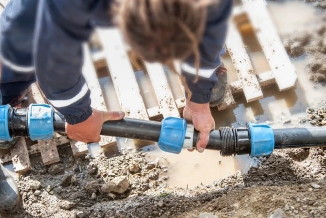 Plumber performing underground pipe installation in Santa Barbara for residential repiping service.